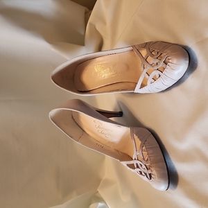 Beige heels with woven toes with pleated leather accents..